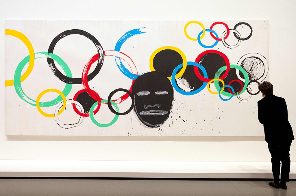 A visitor looks at “Olympic Rings”, an acrylic painting.