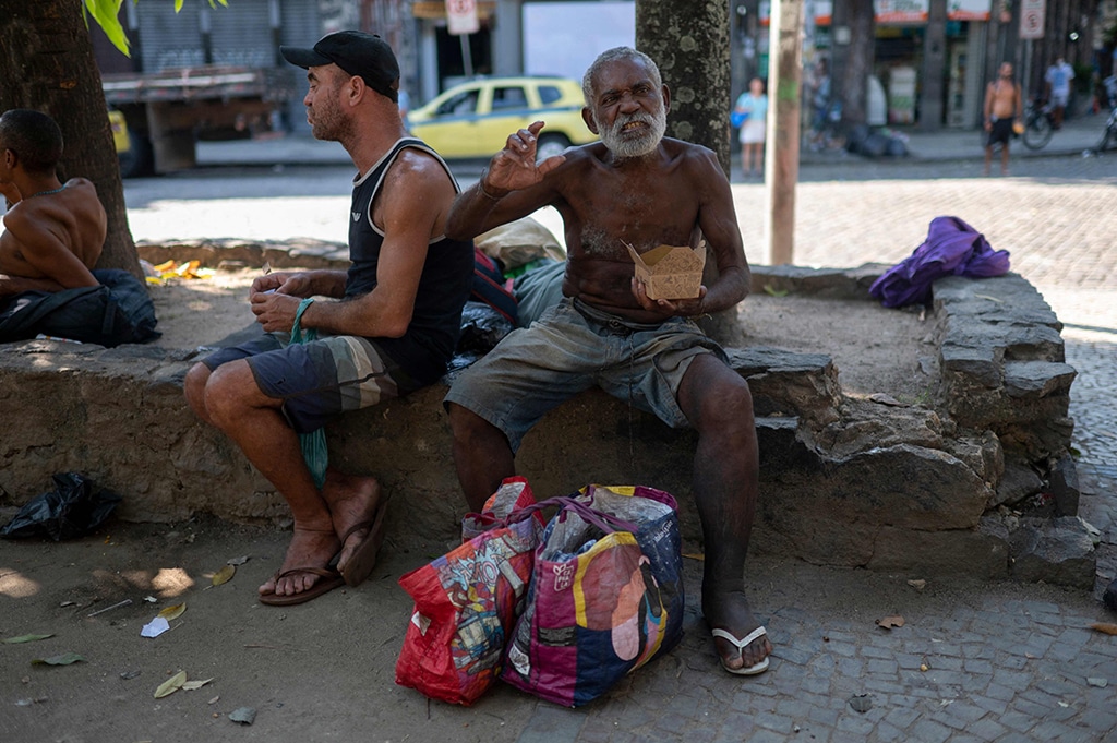 A homeless man eats a meal donated by Brazilian chef Carlos Alberto da Silva, known as Nego Breu, and his team at the Lapa neighborhood in Rio de Janeiro, Brazil.