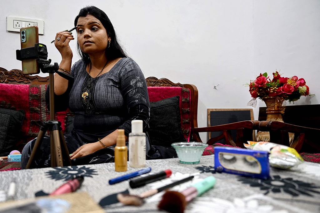 Social media make-up influencer Kavita Jadon, 34, makes tutorial videos with her phone at home in Bulandshahr, Uttar Pradesh.