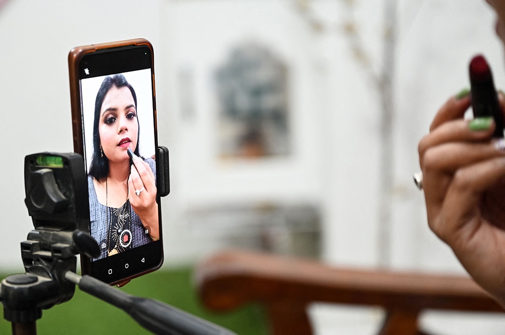 Social media make-up influencer Kavita Jadon, 34, makes tutorial videos with her phone at home in Bulandshahr, Uttar Pradesh.