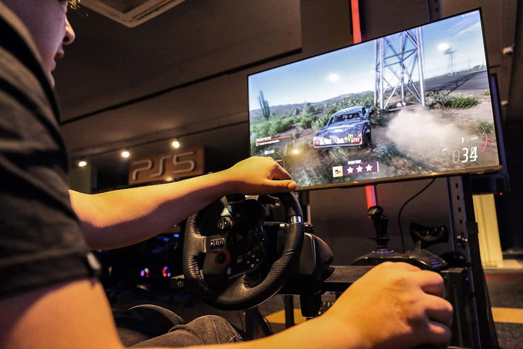 In this picture a youth plays an electronic auto sports game on a dedicated car simulator at a video gaming centre in Libya's capital Tripoli.