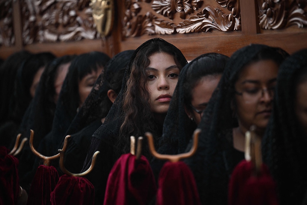 Women carry the procession float of the Virgin of Sorrows through the streets of the historic center of Guatemala City.