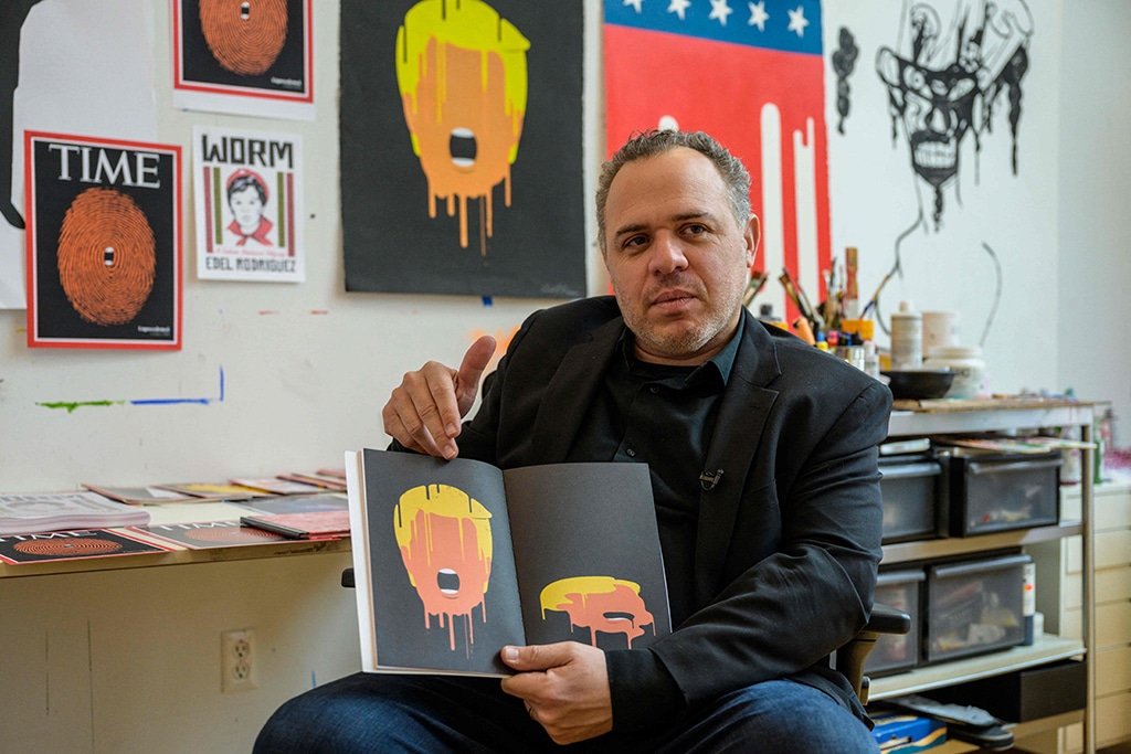 Cuban American artist and illustrator Edel Rodriguez shows his illustrations created during the Trump administration in his studio.
