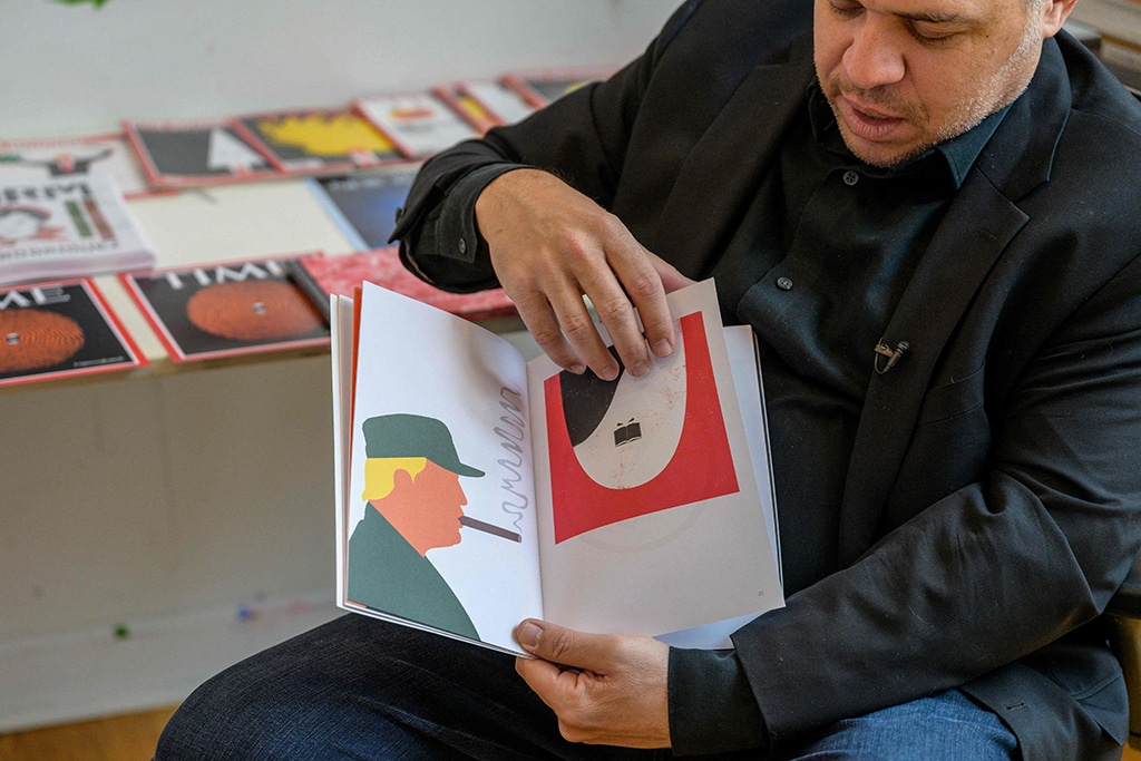 Cuban American artist and illustrator Edel Rodriguez shows his illustrations created during the Trump administration in his studio.