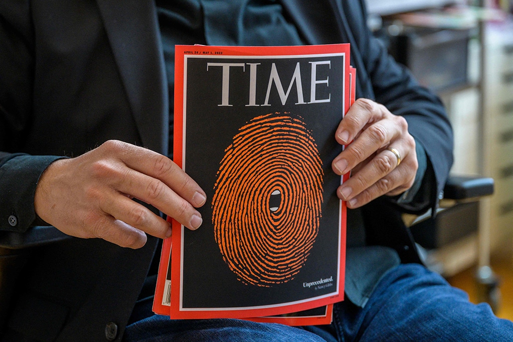Cuban American artist and illustrator Edel Rodriguez shows holds up his illustrations on the cover of Time.