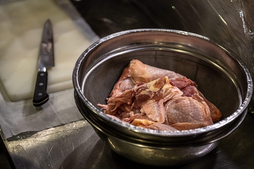 This picture shows raw chicken being prepared at an izakaya bar in Tokyo.