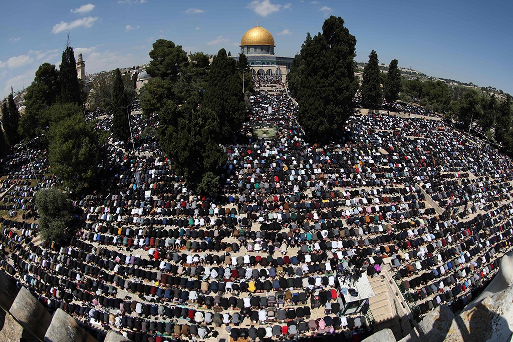 A picture taken with a fisheye lense shows Palestinian worshippers gathered to pray outside the Dome of the Rock in Jerusalem's Al-Aqsa mosque compound.