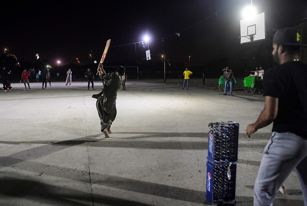 Youngsters play during the tape ball night cricket tournament.