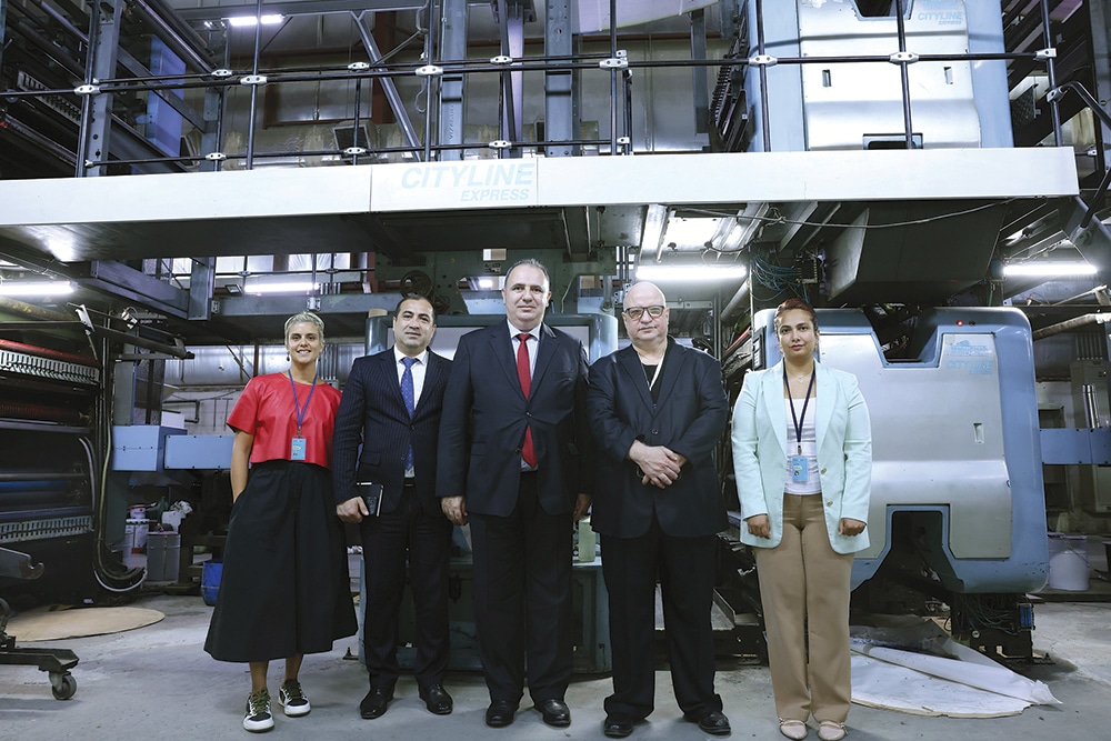 (From left) Jana Al-Naqeeb, Consul Merdawood Sultanov, Ambassador Emil Karimov, Mustafa Qamhiya and Faten Omar pose for a photo in front of the printing press.