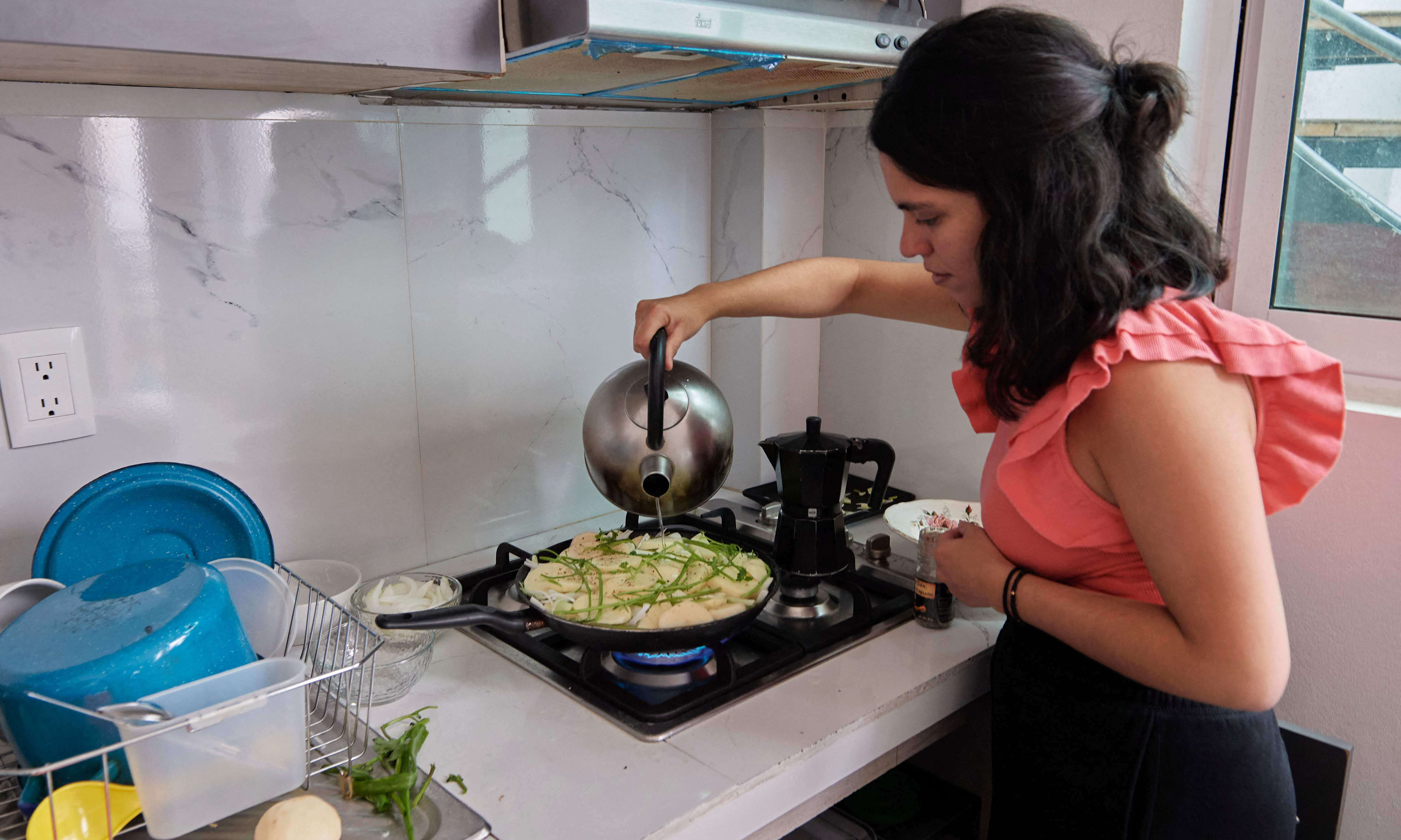 Venezuelan migrant Laura Linares prepares turmada, a Venezuelan Andean dish, at her house.