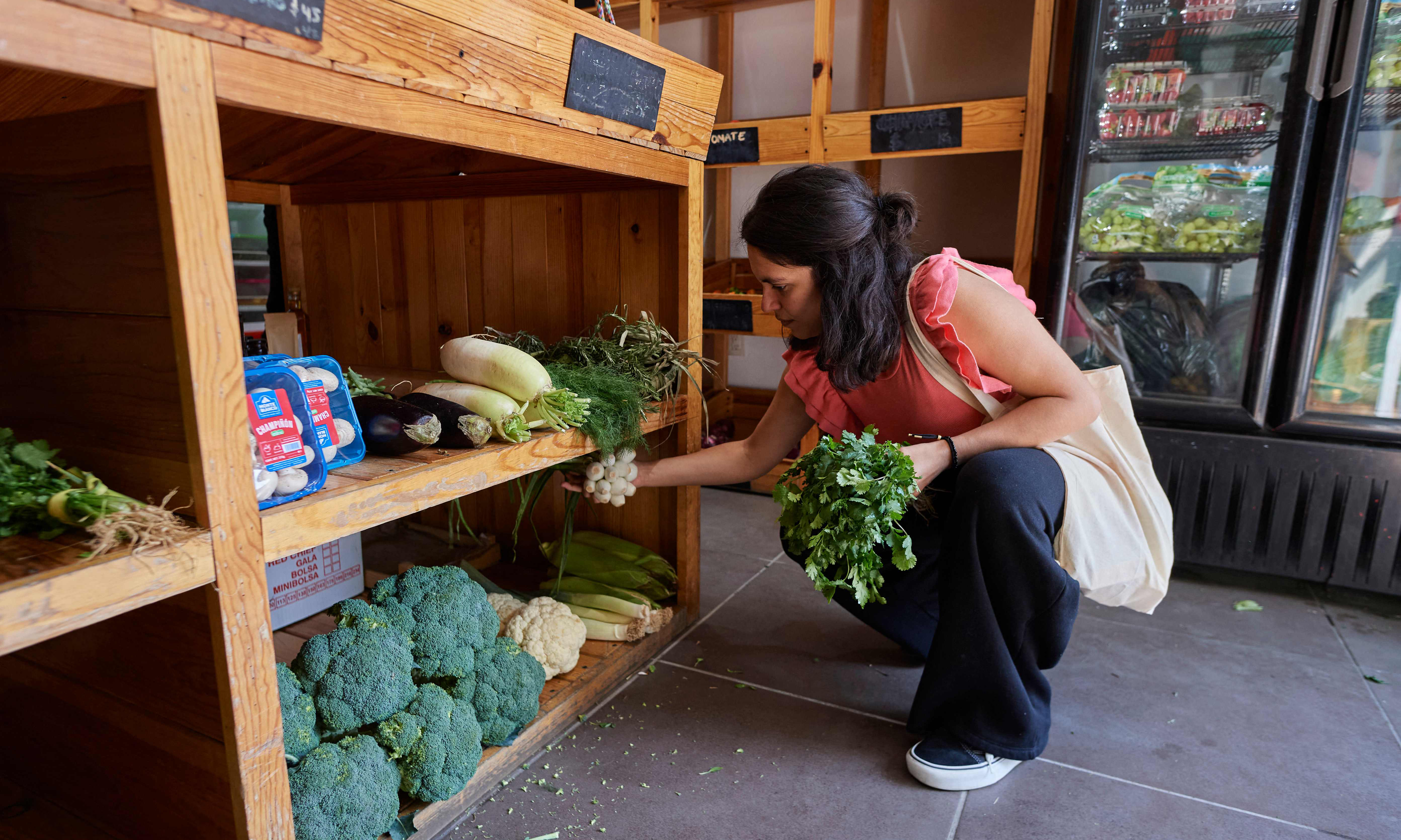 Venezuelan migrant Laura Linares buys vegetables to prepare turmada.