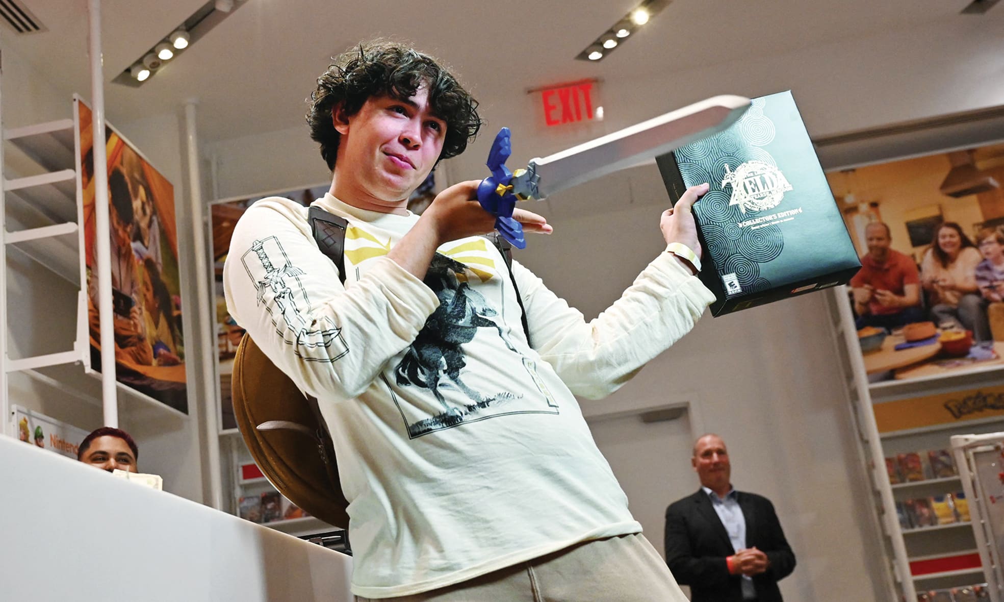 First customer David Castillo wields the Master Sword as he poses for a photo after purchasing 'The Legend of Zelda: Tears of the Kingdom' during a launch event for the game at a Nintendo store in New York.