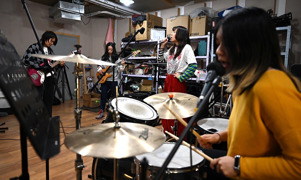 This photo shows members of punk band Xiaowang (from left to right); guitarist Qiuqiu, bass player Tongtong, lead singer Yuetu, and drummer Zaozao rehearsing in Beijing.
