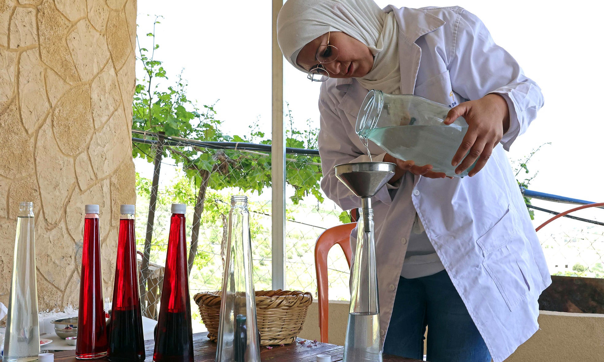 Zahraa Sayed Ahmed produces rose water from Damascena (Damask) roses, at her house in the village of Qsarnaba.