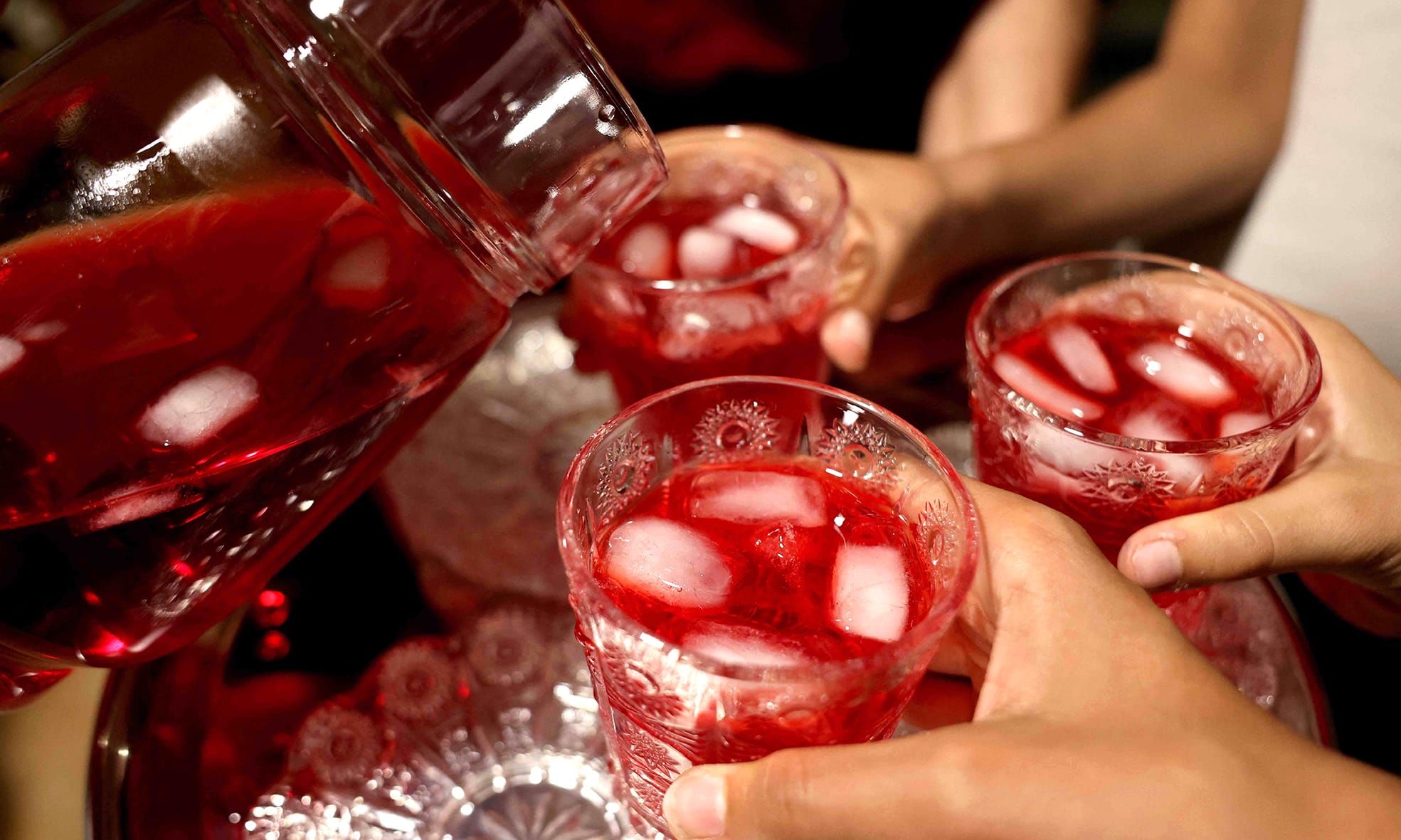 A woman serves a drink made of rose syrup at a house in Byblos.