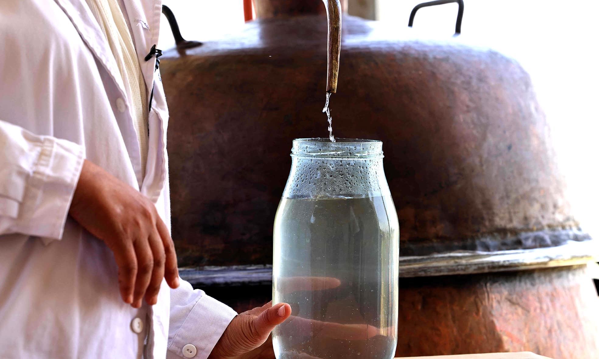 Zahraa Sayed Ahmed produces rose water from Damascena (Damask) roses, at her house in the village of Qsarnaba.