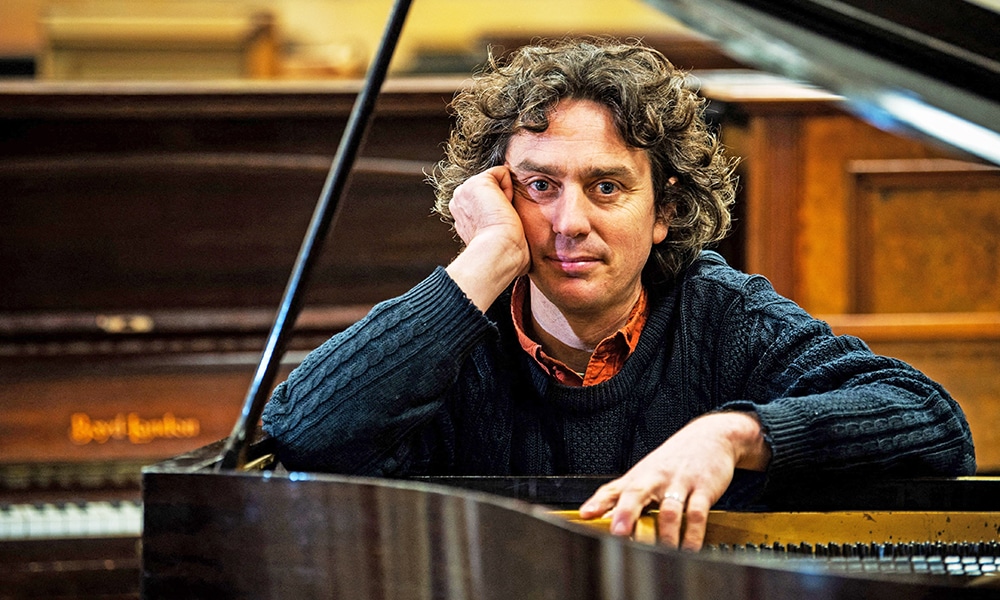 Artist and Musician Tim Vincent-Smith, Co director of Painodrome, a charity centre aiming a the refurbishing and repairing pianos, poses for photographs in their atelier in a former department store near the port of Leith.