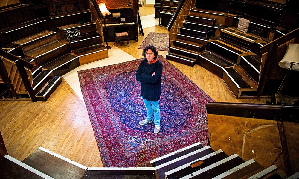 Artist and Musician Tim Vincent-Smith, Co director of Painodrome, a charity centre aiming a the refurbishing and repairing pianos, poses for photographs in their atelier.