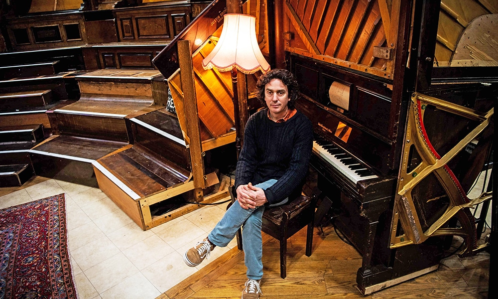 Artist and Musician Tim Vincent-Smith, Co director of Painodrome, a charity centre aiming a the refurbishing and repairing pianos, poses for photographs in their atelier.