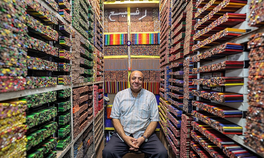 Mohammad Rafi, a seller of colored pencils at the Grand Bazaar in Tehran, sits at his shop.