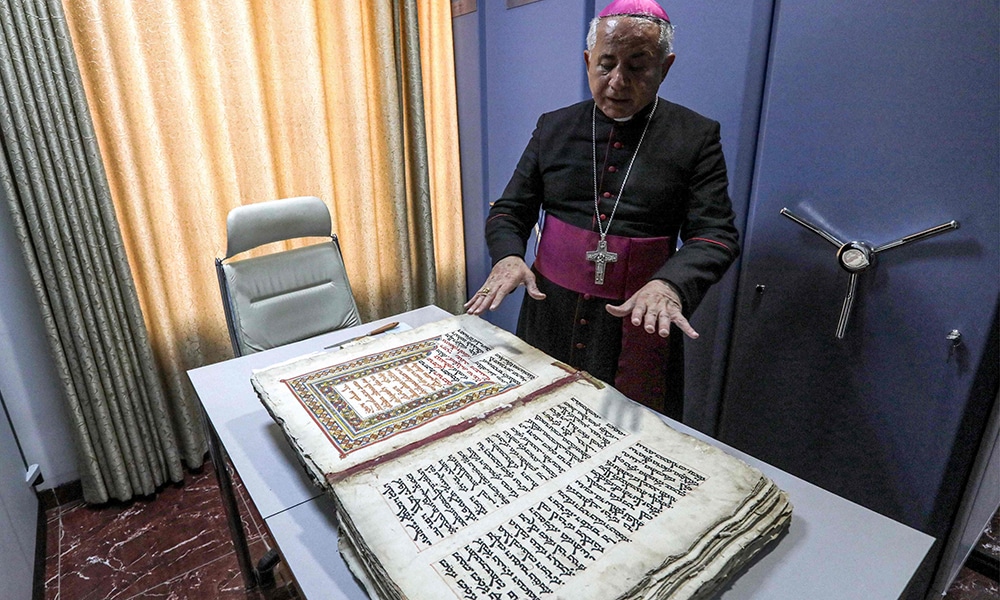 The Chaldean Catholic Archbishop of Mosul Michaeel Najeeb presents an old Syriac-language Christian codex at the Eastern Manuscript Digitisation Centre (CNMO) in Arbil, the capital of Iraq's autonomous northern Kurdish region.