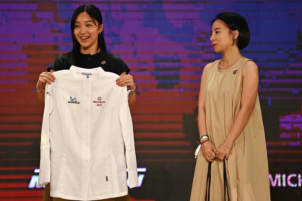 Nguyen Bao Anh (left) of the of the Tam Vi restaurant holds her Michelin Star winner chef's whites at the Michelin Guide ceremony in Hanoi.