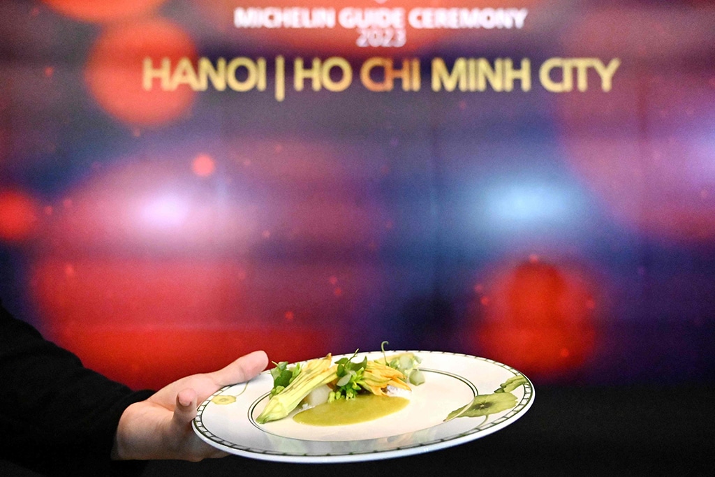 A waiter serves dishes at the Michelin Guide ceremony in Hanoi.
