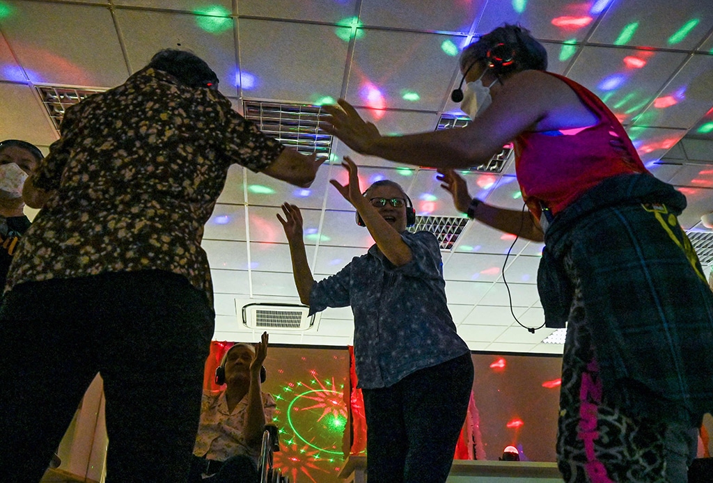 Residents with dementia participating in a silent disco at Apex Harmony Lodge in Singapore.