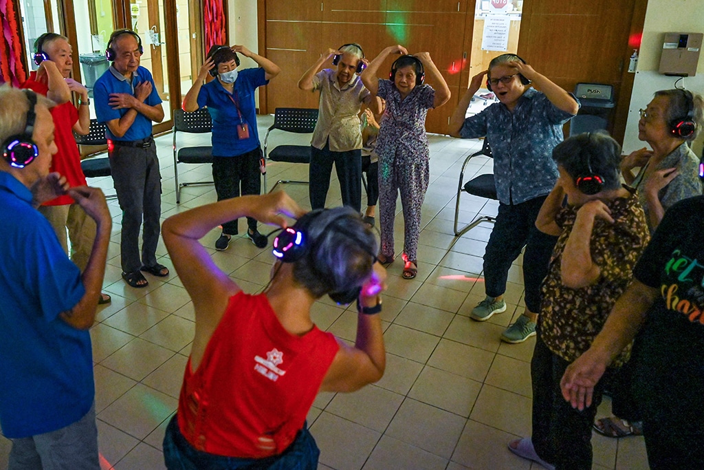 Residents with dementia participating in a silent disco at Apex Harmony Lodge in Singapore.