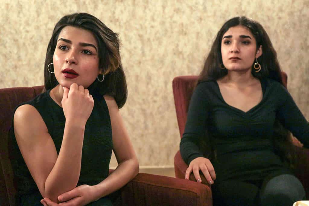 Syrian-Kurdish refugees and musicians Norshean Salih (left), 23, and her sister Perwin Salih, 20, talk in Arbil, the capital of the autonomous Kurdish region of northern Iraq.