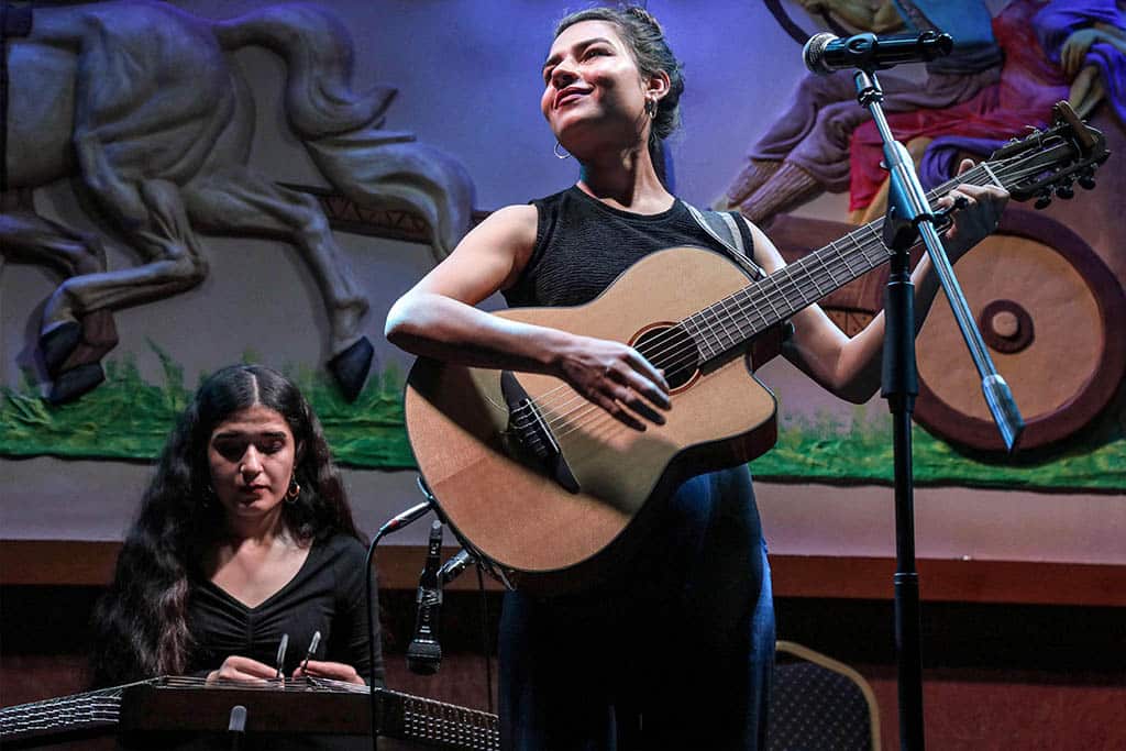 Syrian-Kurdish refugees and musicians Norshean Salih (right), 23, and her sister Perwin Salih, 20, perform in Arbil, the capital of the autonomous Kurdish region of northern Iraq.