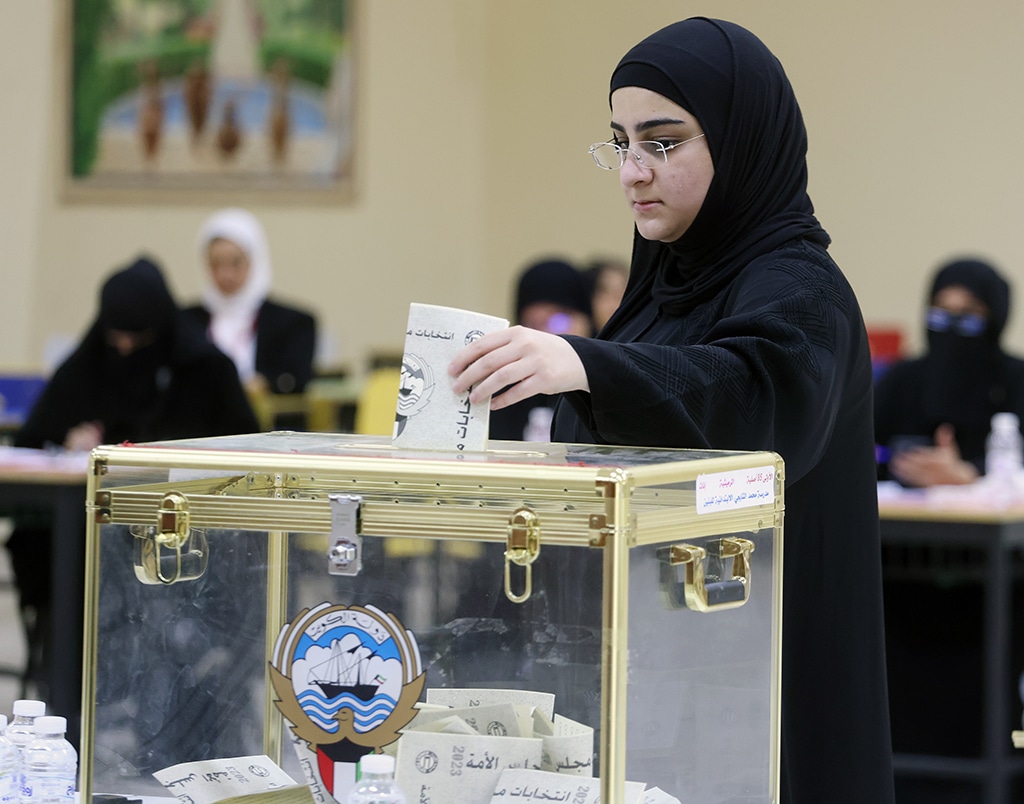 Kuwaiti women cast their votes during parliamentary elections in Kuwait City on June 6, 2023.
