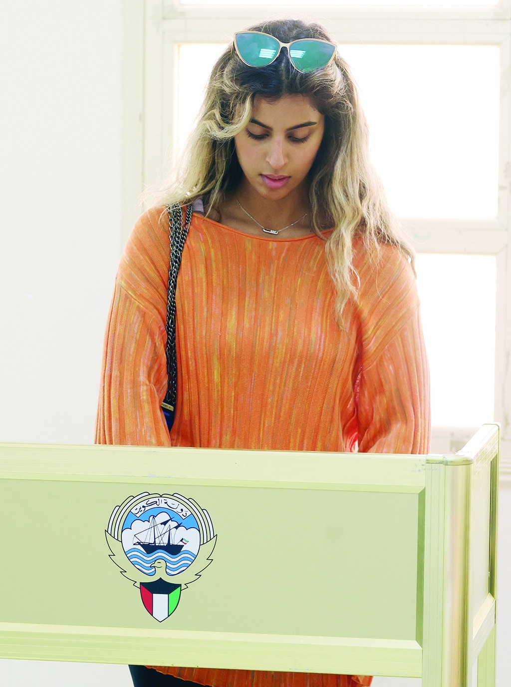 A Kuwaiti woman casts her vote during parliamentary elections in Kuwait City on June 6, 2023.