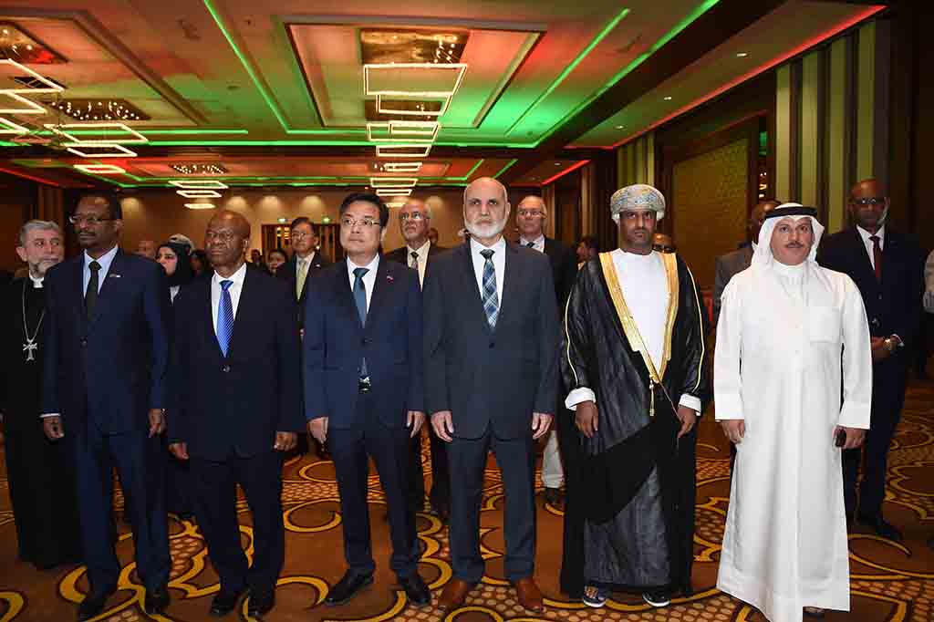 Ambassadors and officials stand for the national anthem during the reception.