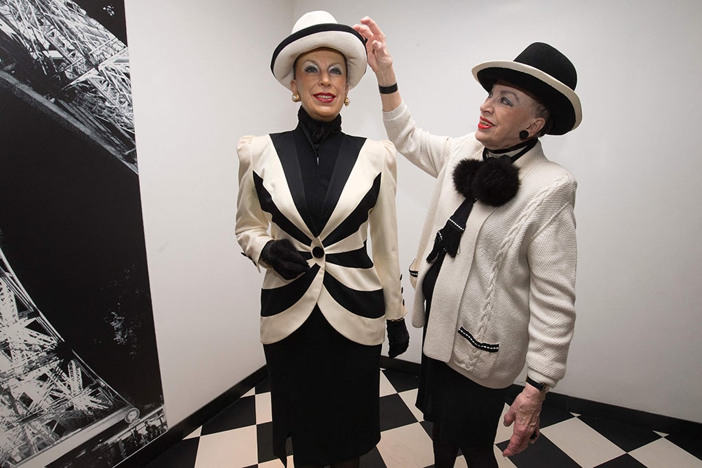 French former founder and president of the Miss France committee Genevieve de Fontenay poses next to her waxwork model at the Grevin museum in Paris.