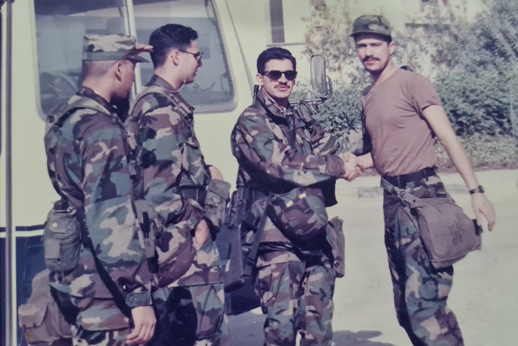 Hussein is seen with fellow service men during the Iraqi invasion.