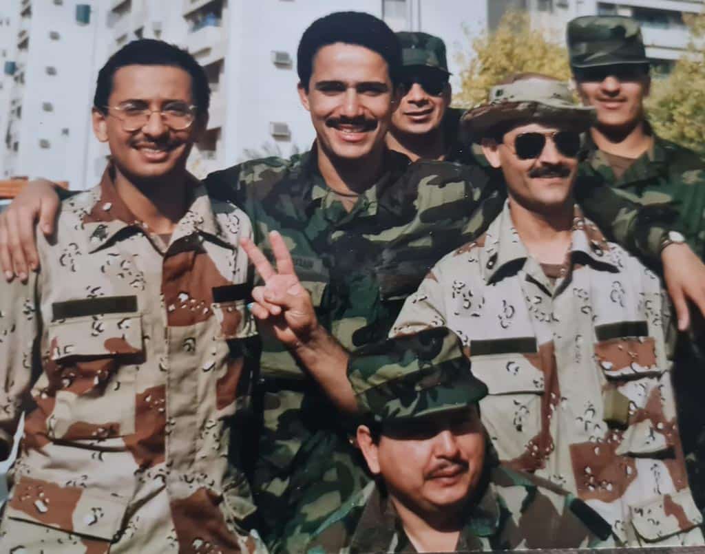 Hussein is seen with fellow service men during the Iraqi invasion.