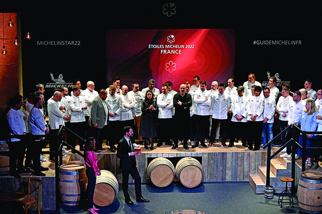 Chefs celebrate on stage after being awarded a first Michelin star. 